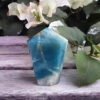 This includes the Caribbean Calcite Generator shown, about 1.90 x 1.45”, drawstring pouch & gift box. Color variances, nicks, imperfections and cracks are the nature of genuine gemstones, crystals and minerals. Caribbean Calcite is a combination of light blue Calcite, brown & white Aragonite. Lemurian Priestesses used blue calcite to access other realms. It opens doorways to help you access divine inspiration to help bring your ideas into reality. It connects you to your highest truth and is connected to the Throat Chakra. Brown Aragonite aids in personal growth & transformation while helping you to center & balance, it’s connected to the Sacral Chakra. White Aragonite helps to purify & heal, brings in light energy from higher realms to help connect you to higher beings & is connected to your Third Eye, Crown & Soul Star Chakras. Pyrite adds the energies of confidence, willpower & vitality. Generators send energies up and out, raising vibrations and keeping them high.