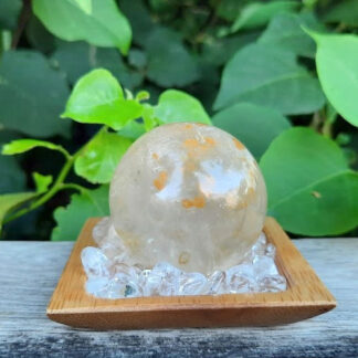 This set includes the Golden Healer Quartz Sphere shown, about 1.55,” on a bed of Clear Quartz crystals to amplify the energy. You'll also receive a bamboo tray, drawstring pouch & gift box. Color variances, nicks, imperfections and cracks are the nature of genuine gemstones, crystals and minerals. Keep on your bedside table to connect w/ your subconscious while dreaming or in any room to boost manifesting. Hold in a palm during meditation or place on any Chakra to activate / balance it. Golden Healer Quartz is a high vibration crystal that can scan your entire body both physically & energetically to help you find blockages to help you clear them. It’s not an overnight process but you will notice the rewards you’ll reap. It stimulates your creativity and opens you up to new possibilities of success bringing you abundance and prosperity. Aligns & connects all of your Chakras from your earthly body to Higher Realms. May this bring you creativity, success, abundance & prosperity.