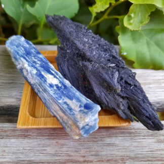 This includes the Blue & Black Kyanites shown, about 3.65 & 4.20", a bamboo tray, drawstring pouch & gift box. Color variances, nicks, imperfections and cracks are the nature of genuine gemstones, crystals and minerals. Please note that it's common for Raw Blue & Black Kyanite to easily flake & shed. Blue Kyanite is said to be the most powerful stone for balance & alignment. Opens you to trusting your intuition & brings wisdom to follow your inner vision to reach your highest good. Helps to support your communication w/ others while you speak your truth. Opens your psychic channels bringing ease of downloads from higher realms & is the only stone known to instantly balance and align all Chakras! Black Kyanite is the only crystal that can instantly clear negative energies. It can also be used to cut cords with others, provides a protective shield to keep your energy safe from “energy vampires”. It’s grounding, calming & makes you more aware of your intuition. It never needs to be cleared & balances all Chakras, especially the Earth Star & Root Chakras.